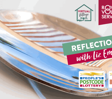 a close up of a spoon reflecting the surroundings