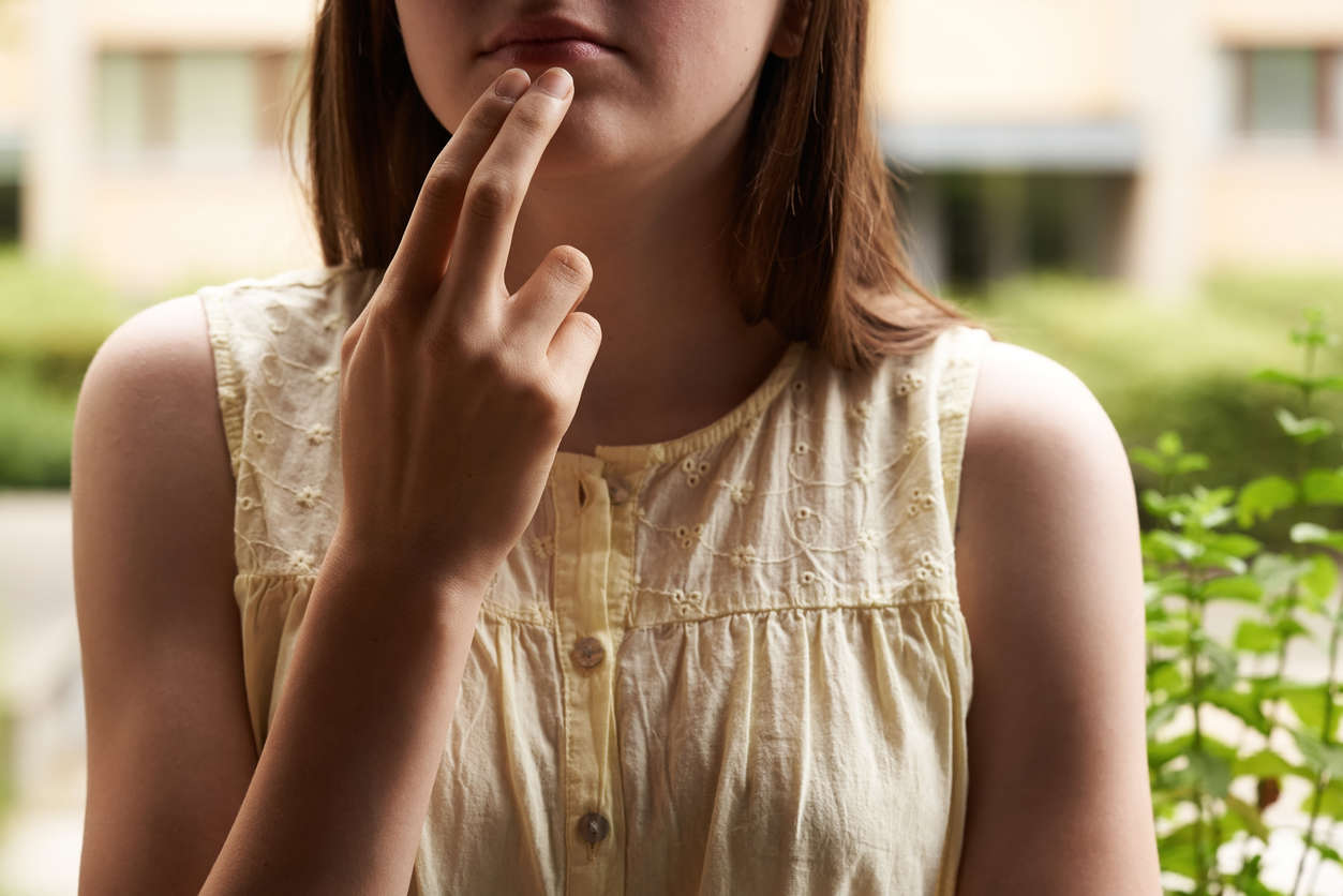 A woman practicing EFT Tapping outside in nature