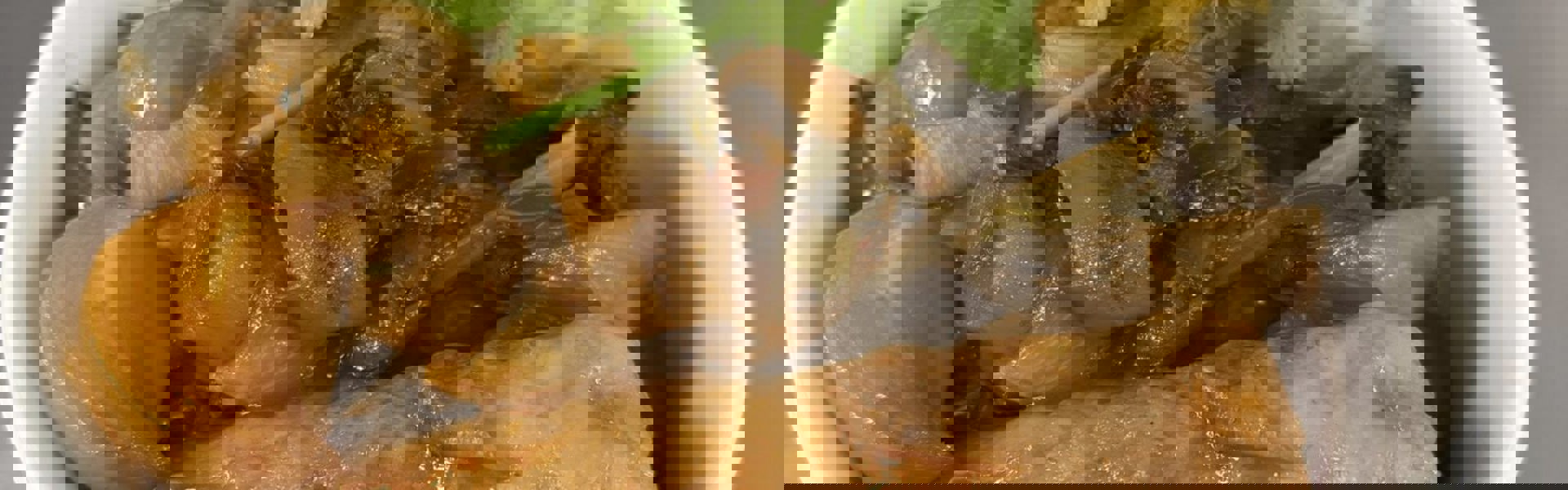 Main image: a hearty sausage and Guinness stew with Irish boxty ( a potato pancake) on the side and a garnish of parsley on top. 