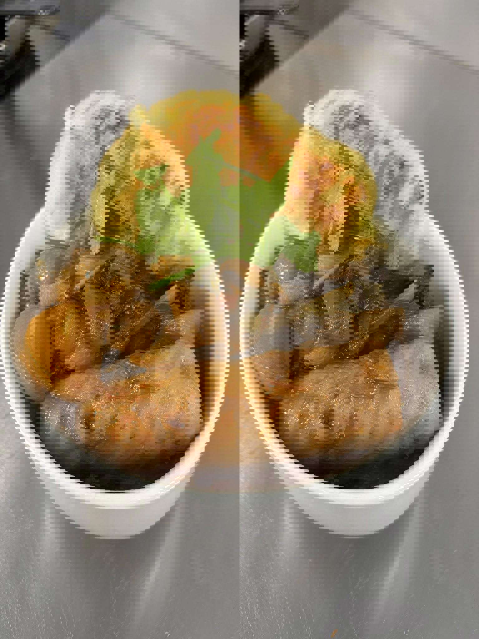 Main image: a hearty sausage and Guinness stew with Irish boxty ( a potato pancake) on the side and a garnish of parsley on top. 