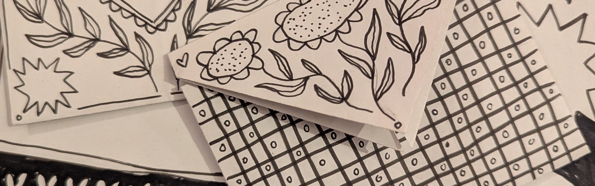 Main Image:  Black lettering and floral illustrations on white paper letters