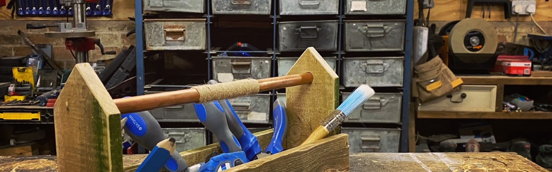 a pallet toolbox with blue wood working tools inside made by Max McMurdo