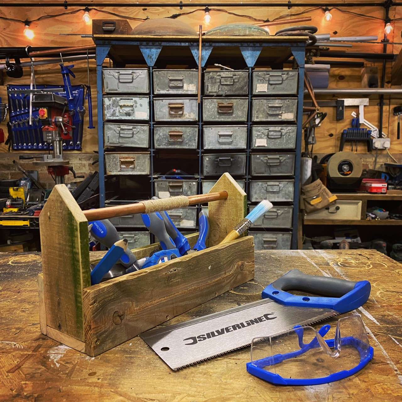 a pallet toolbox with blue wood working tools inside made by Max McMurdo