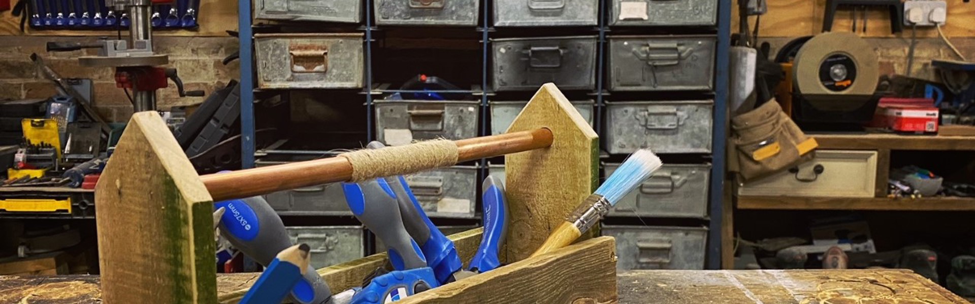 a pallet toolbox with blue wood working tools inside made by Max McMurdo