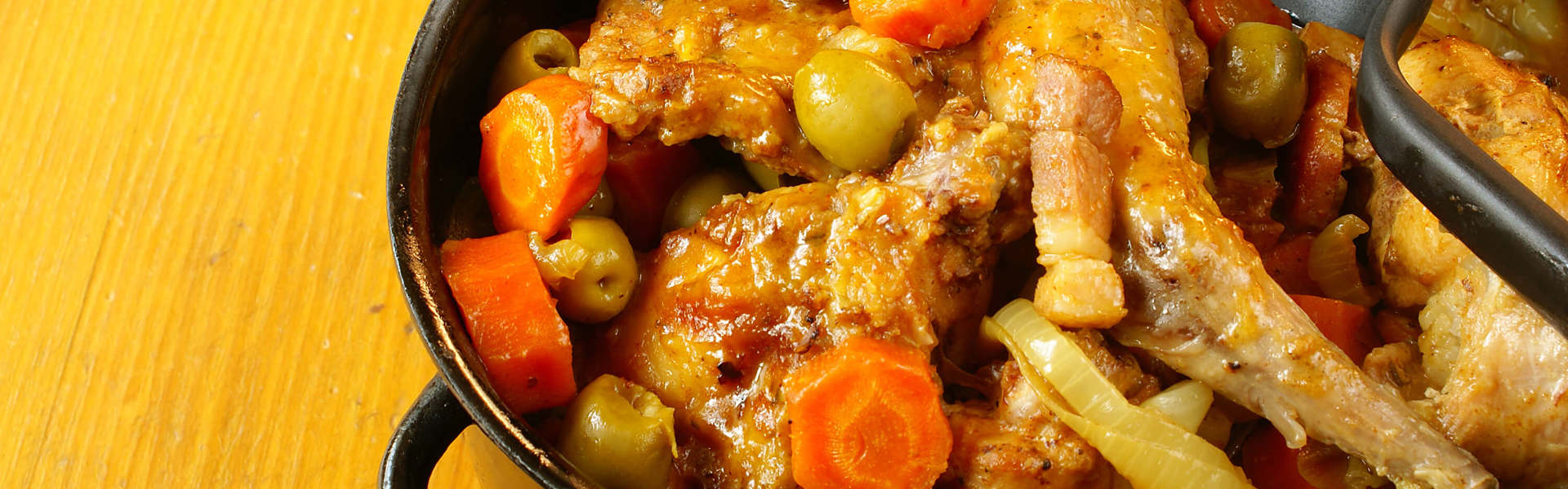 Main Image: Photo of an authentic Bajan brown stew chicken dish.