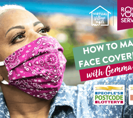 a woman wearing a pink paisley print facemask