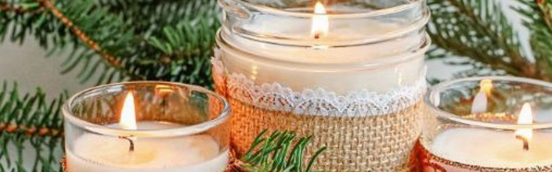 Main image: three homemade scented candles with festive ribbon and decoration.