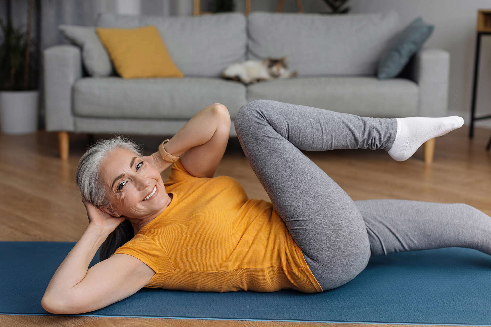 A woman doing floor exercises at home 